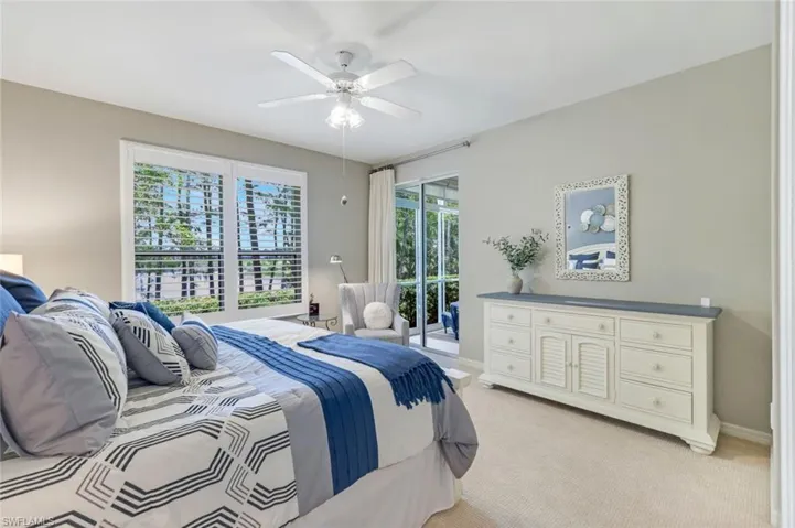 Bedroom with access to exterior, light colored carpet, and ceiling fan