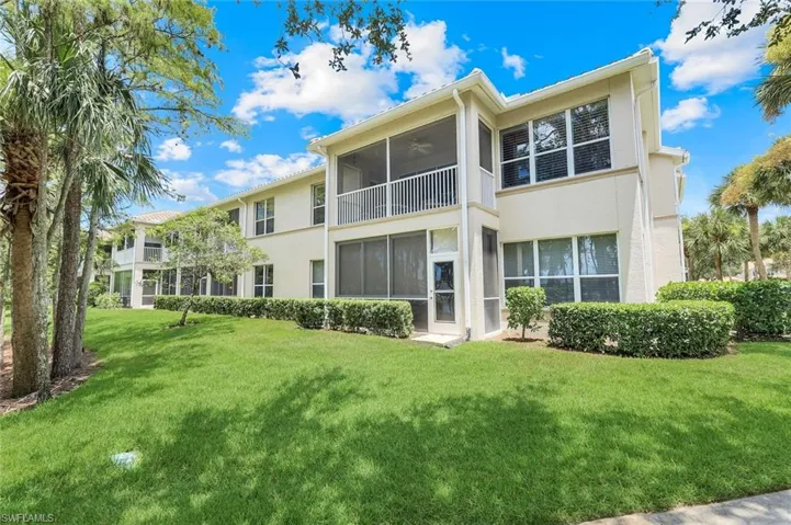 Back of property with stucco siding, a lawn, a sunroom, and a ceiling fan