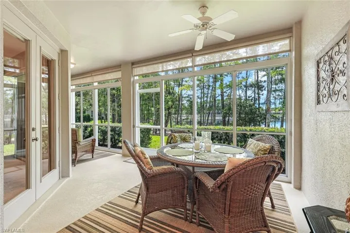 Sunroom / solarium with a ceiling fan, french doors, a textured wall, outdoor dining space, and carpet floors