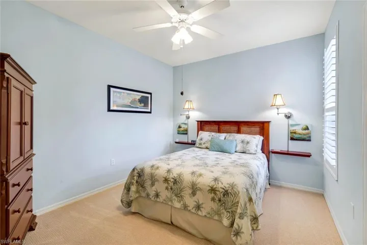 Bedroom featuring light colored carpet and a ceiling fan