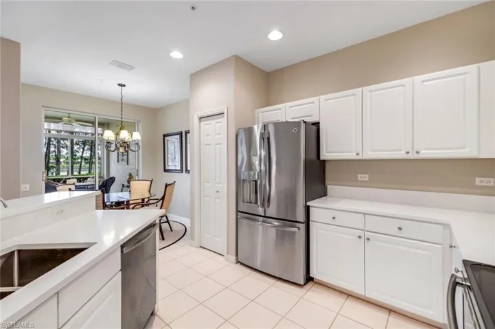 Kitchen featuring appliances with stainless steel finishes, white cabinets, pendant lighting, and recessed lighting