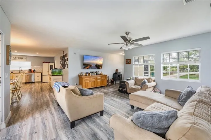 Living area with wood finished floors and ceiling fan
