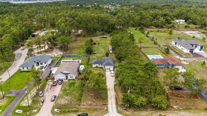 Aerial view of residential area featuring a forest