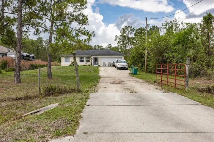 Single story home featuring driveway and an attached garage