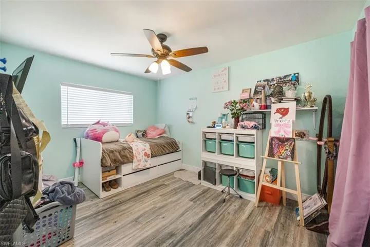 Bedroom featuring wood finished floors and ceiling fan