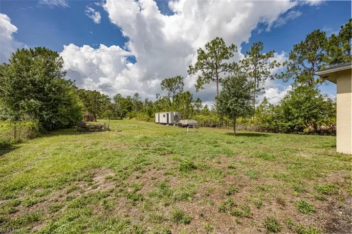 View of grassy yard with a shed