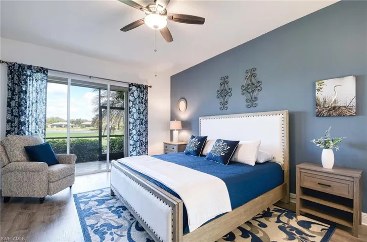 Bedroom with ceiling fan, access to exterior, and wood-type flooring