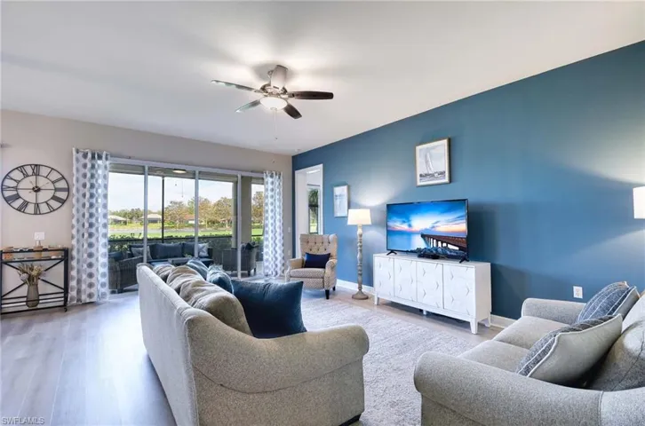 Living room featuring hardwood / wood-style flooring and ceiling fan