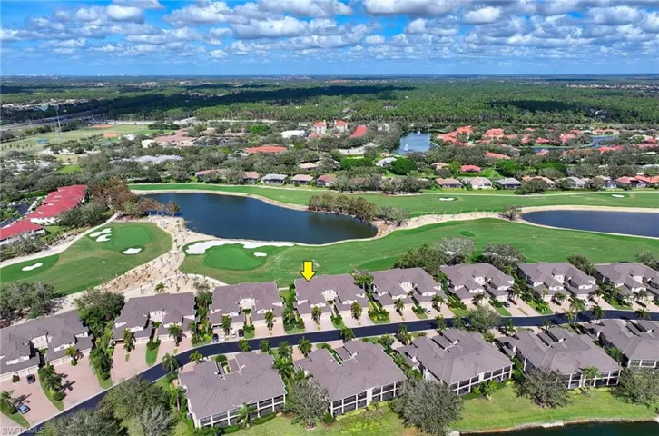 Birds eye view of property with a water view