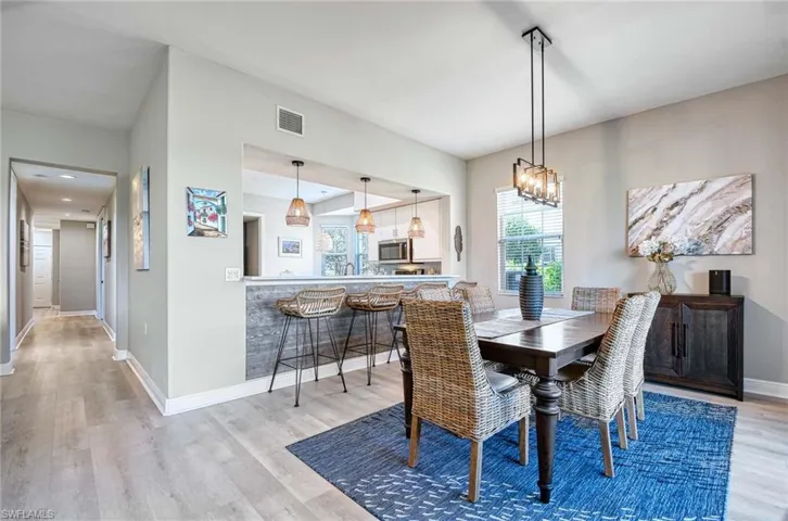 Dining space featuring light hardwood / wood-style flooring and an inviting chandelier