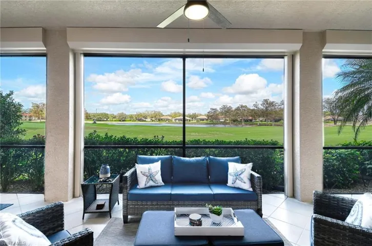 Sunroom with ceiling fan and views of North golf course and lake.