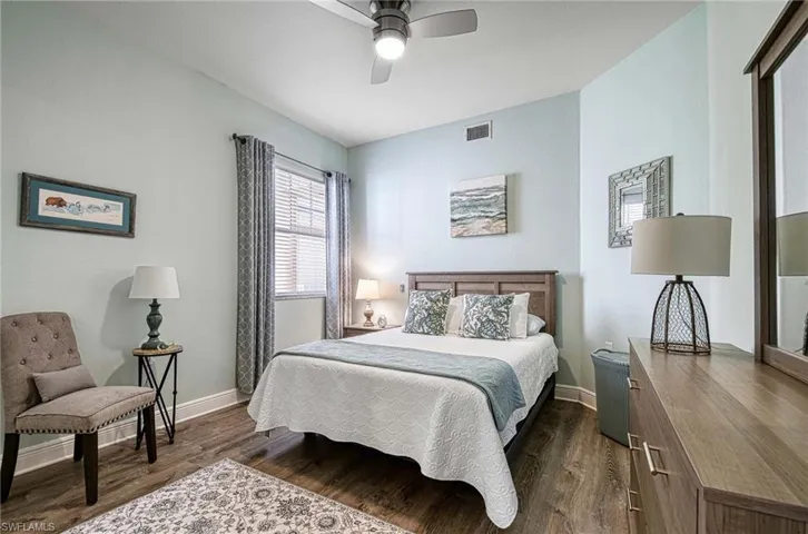 Bedroom with dark wood-type flooring and ceiling fan