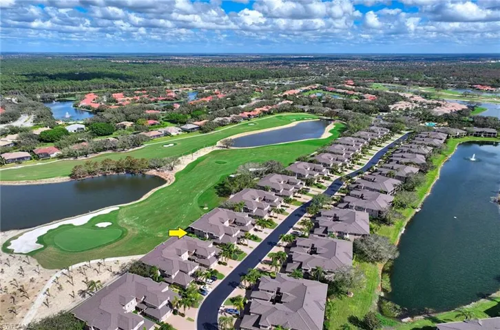 Birds eye view of property with a water view