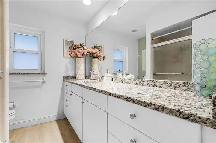 Main Full bath with light wood-style vinyl floors, a tub, shower stall, new granite vanity, and recessed lighting