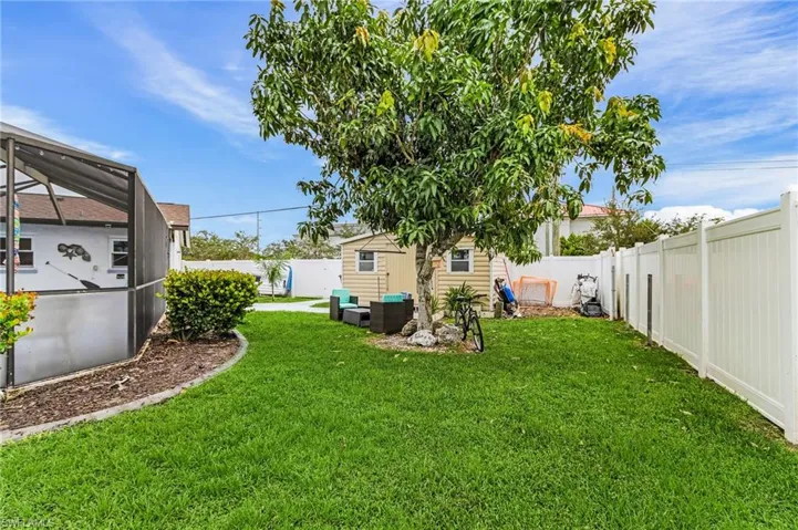 Fenced backyard with a new storage shed with power.