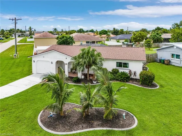 Mediterranean / spanish-style home featuring an attached garage, stucco siding, concrete driveway, a shingled roof, and a residential view