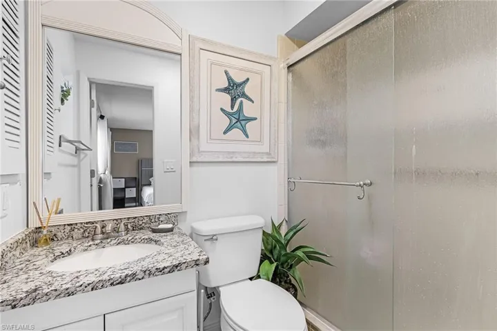 Full hall bath with a shower tub combo & granite vanity