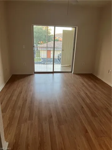 Empty room featuring light wood-style flooring and ceiling fan