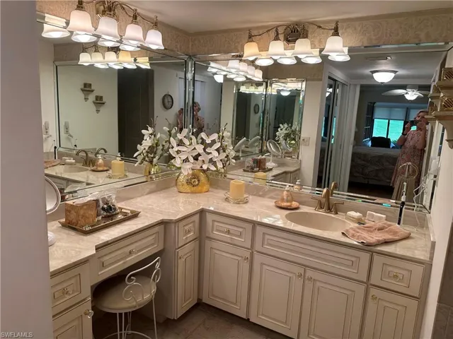 Bathroom with tile patterned flooring, vanity, and ceiling fan