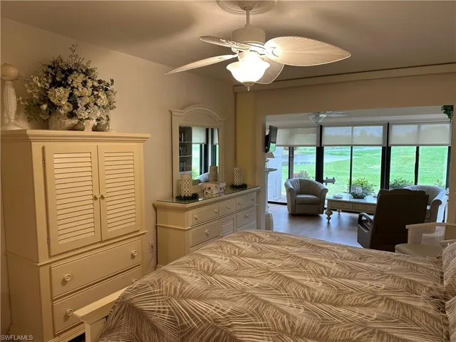 Bedroom with access to exterior, ceiling fan, and wood-type flooring