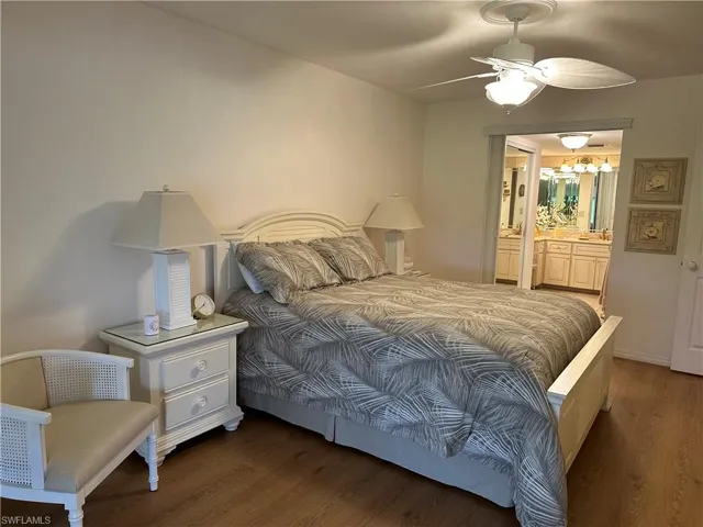 Bedroom with connected bathroom, ceiling fan, and wood-type flooring