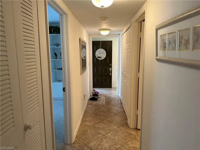 Hall featuring light tile patterned floors