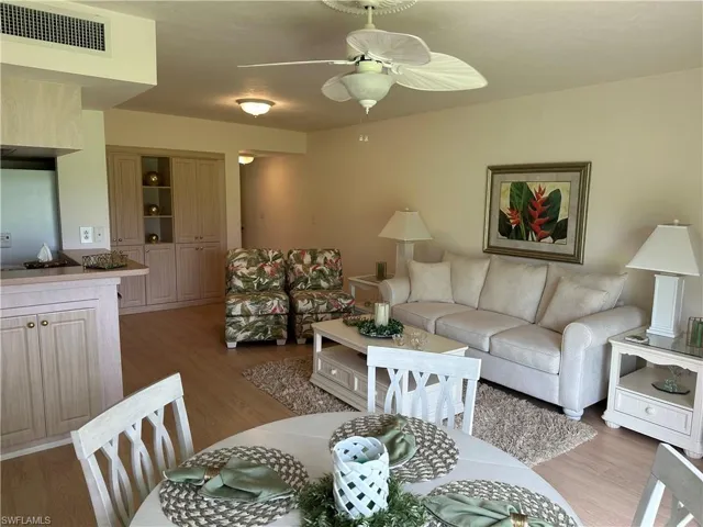 Living room featuring ceiling fan and dark hardwood / wood-style flooring