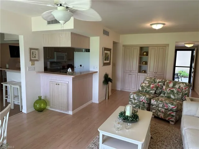 Living room featuring light hardwood / wood-style floors and ceiling fan