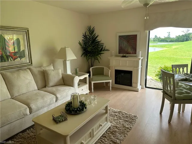 Living room with light hardwood / wood-style flooring and ceiling fan