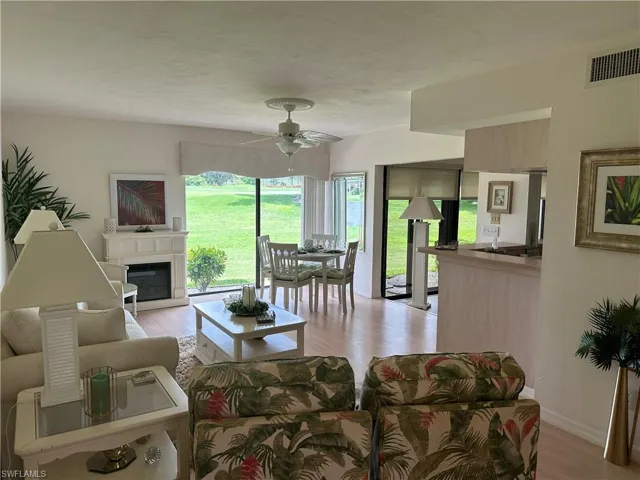 Living room featuring light wood-type flooring and ceiling fan