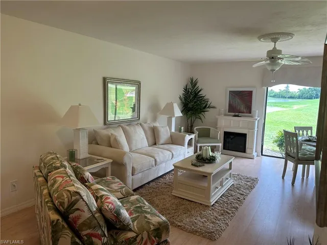Living room featuring light hardwood / wood-style flooring, a wealth of natural light, and ceiling fan