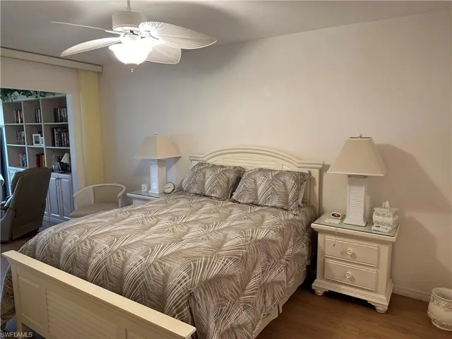 Bedroom with hardwood / wood-style floors and ceiling fan