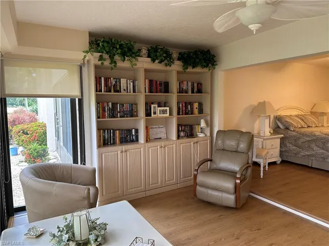 Sitting room featuring ceiling fan, a textured ceiling, and light hardwood / wood-style flooring