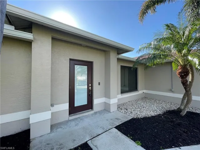 Entrance to property with stucco siding