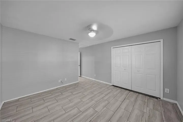 Unfurnished bedroom featuring a closet and ceiling fan