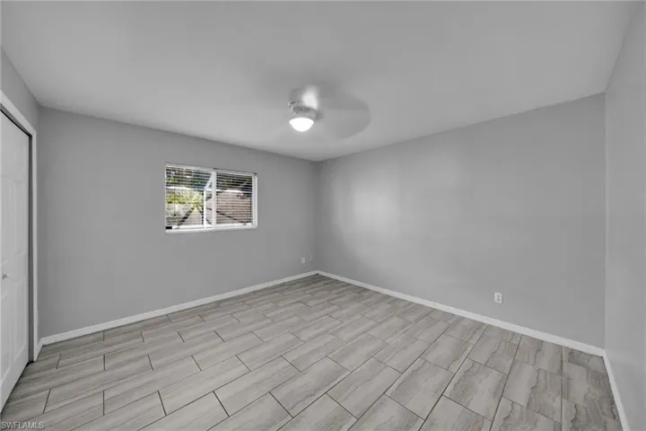 Unfurnished bedroom featuring a closet, ceiling fan, and wood finish floors