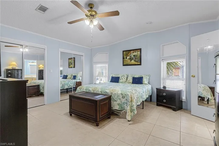 Primary Bedroom with a large room width walk-in closet.