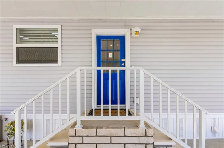 Covered entry with steps from either parking area.