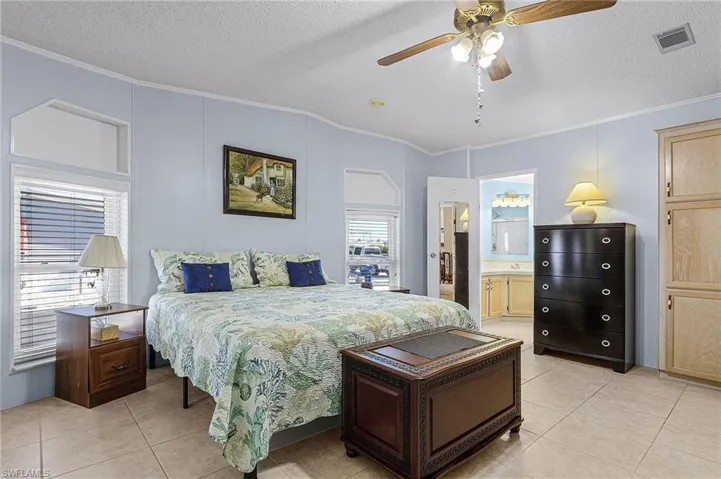 Large primary bedroom with tile floors.