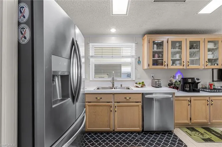 Stainless appliances in the kitchen with a coffee bar.