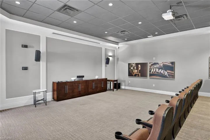 Home theater featuring a paneled ceiling, carpet flooring, and recessed lighting