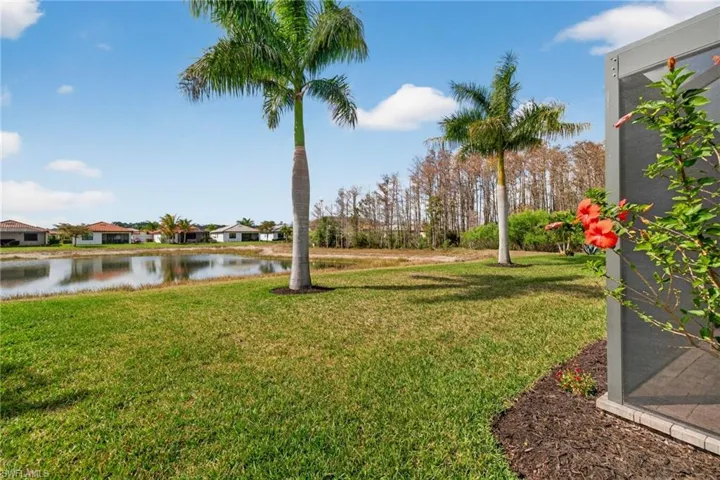 View of green lawn featuring a water view