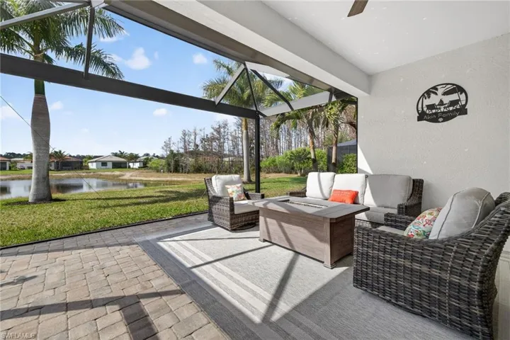 Sunroom / solarium featuring a patio area, a water view, a ceiling fan, and an outdoor hangout area