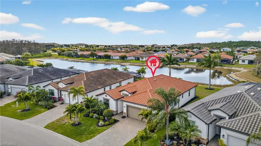 Aerial view of residential area featuring a nearby body of water