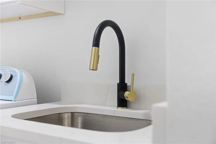 Detailed view of washer / dryer roomand light countertops