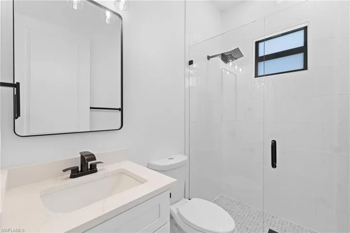 Bathroom with a stall shower and vanity