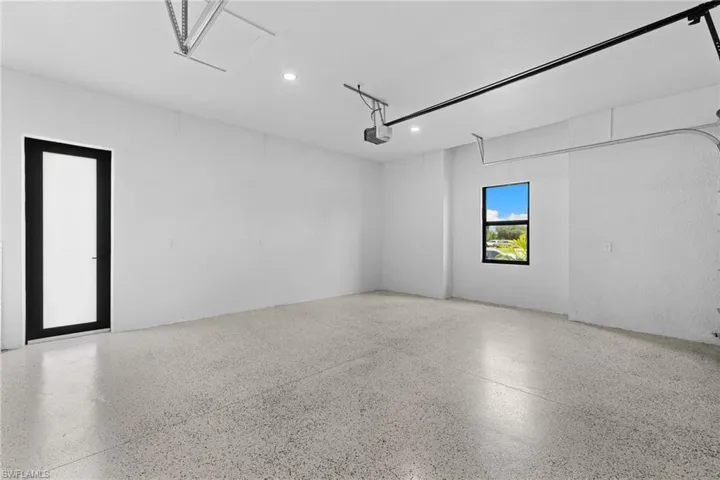 Double car garage with recessed lighting and a garage door opener