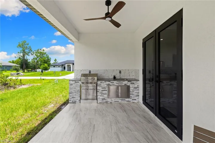 View of patio / terrace featuring area for grilling and ceiling fan