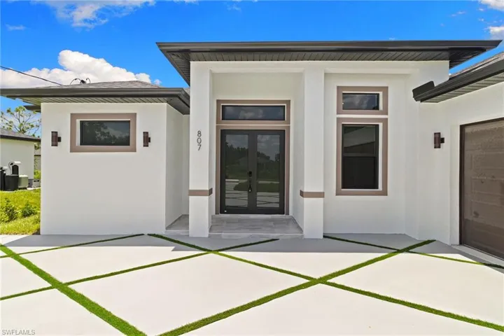 Property entrance with french doors and stucco siding