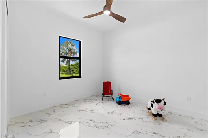Unfurnished room with baseboards and marble finish flooring